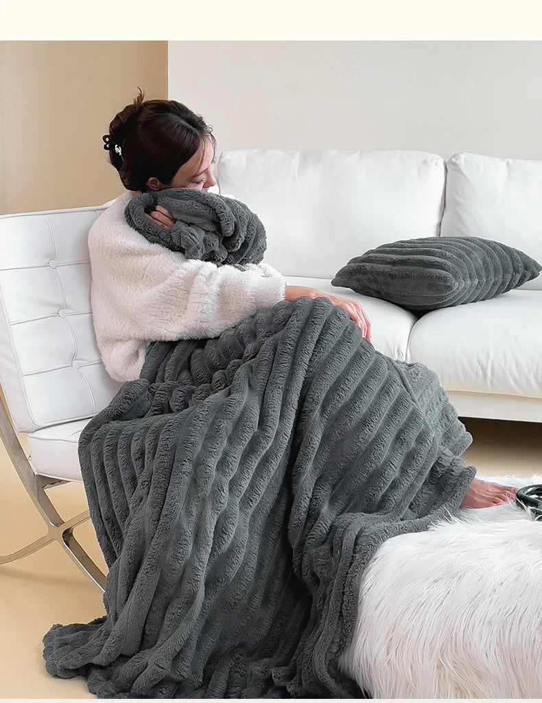 Dark gray ribbed faux fur throw blanket over an armchair