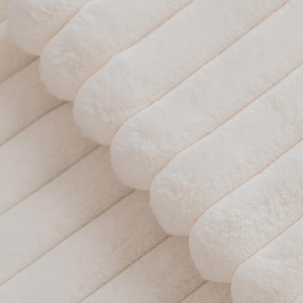 Close-up of the raised stripes on the ivory faux rabbit fur