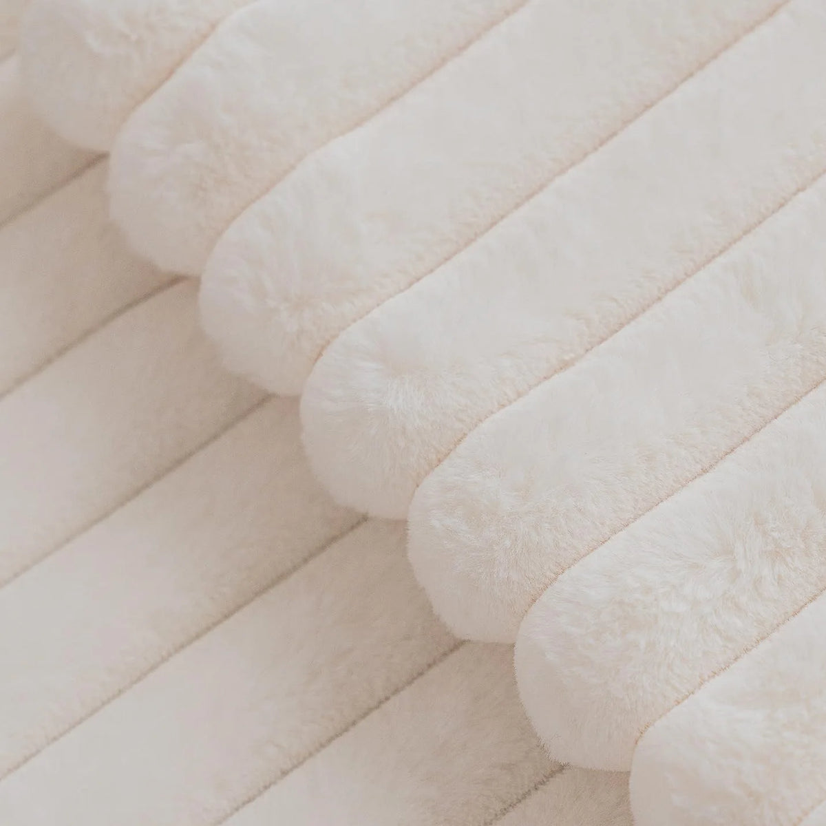 Close-up of the raised stripes on the ivory faux rabbit fur