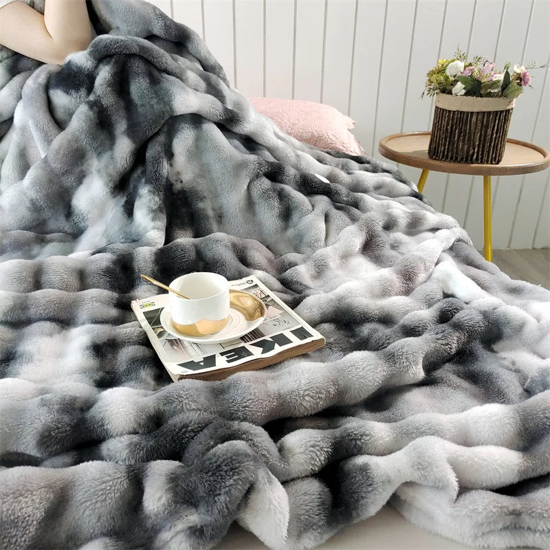 Charcoal gradient bubble faux fur throw on a bed (supplier photo)