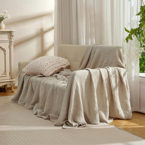 Beige cotton muslin throw draped over a sofa (supplier photo)